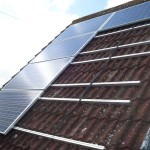 Solar PV Panels being fitted to roof in Alconbury